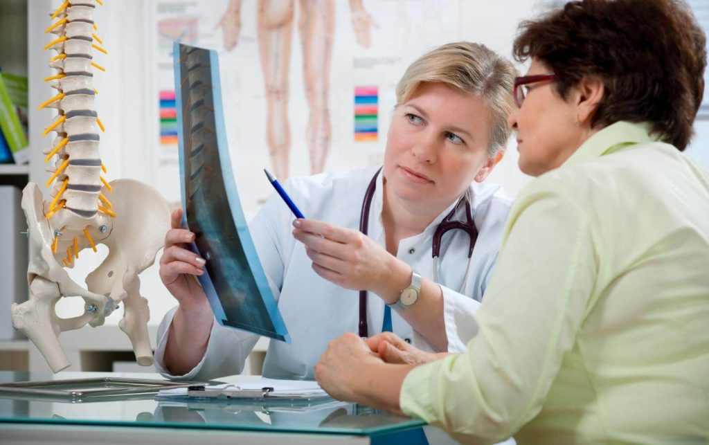 A doctor showing an x-ray to a patient